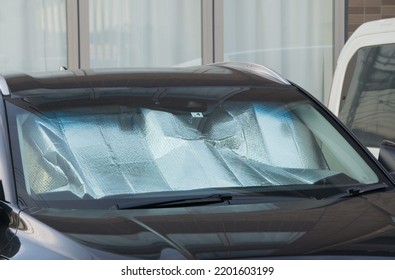 Collapsed Sun Shade Or Sun Reflector On The Windshield The Car