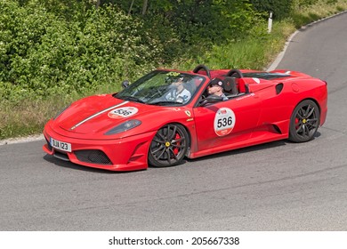 COLLE DI VAL D'ELSA, SI, ITALY - MAY 17: the crew Armstrong - Christie on a Ferrari F430 Scuderia 16M in Ferrari tribute to Mille Miglia, on May 17, 2014 in Colle di Val d'Elsa, Tuscany, Italy 