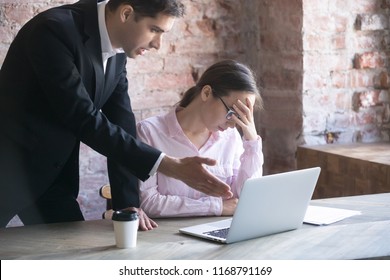 Colleague, boss or advisor explains, criticize the work of young girl intern in office. Subordinate feels guilty tired, frustrated and exhausted, having headache at workplace. Businesspeople arguing
