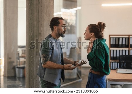 Colleagues arguing in office, problems at work.