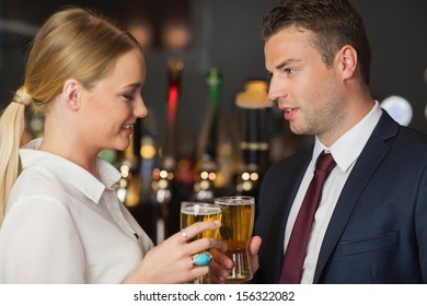 Colleagues Clinking Their Glasses Of Beer While Meeting In A Classy Bar