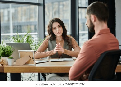 Colleagues converse thoughtfully amid layoffs in a bright, contemporary workspace. - Powered by Shutterstock