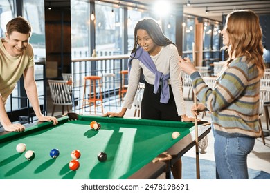 Colleagues from a coworking space challenge their startup team members to a game of pool during a break. - Powered by Shutterstock