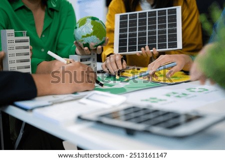 colleagues discussing data working and tablet, laptop with on Construction Site project, green energy and solar panel concept.
