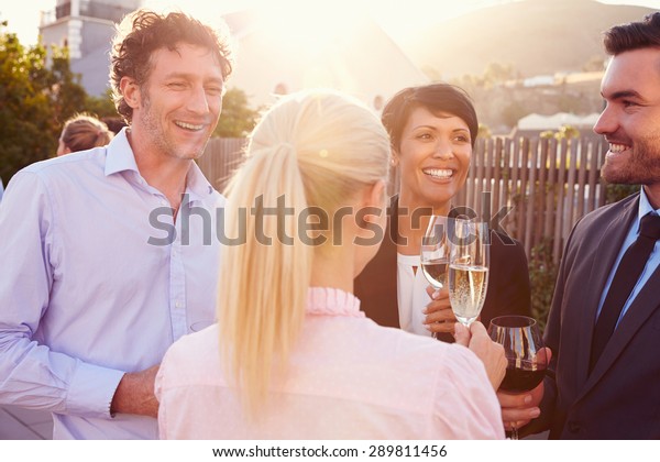 Colleagues drinking
after work at a rooftop
bar