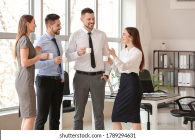 Colleagues Drinking Coffee In Office