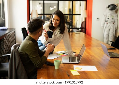 Colleagues drinking coffee in office. Businesswoman and businessman enjoying in fresh coffee while working	 - Powered by Shutterstock