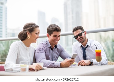 Colleagues enjoying a casual outdoor meeting in Dubai.