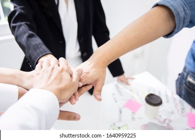 Colleagues Are Gathering Hands To Encourage Each Other To Work. For Successfully Complete Project. Employees Are Working In Modern Office. (Agile And Scrum In Retrospective And Sprint Review Process)