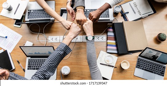 Colleagues giving a fist bump - Shutterstock ID 1717139347