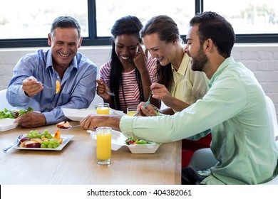 Colleagues having breakfast together in office - Powered by Shutterstock
