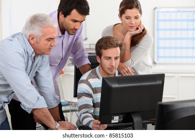 Colleagues looking at computer