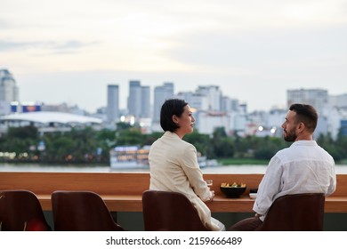 Colleagues Meeting In Rooftop Bar After Work To Talk, Drink Beer And Enjoy City View