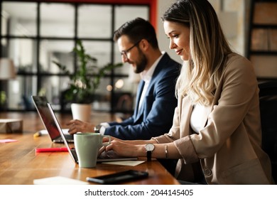 Colleagues in office. Businesswoman and businessman discussing work in office. Two friends working together.	 - Powered by Shutterstock