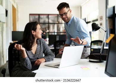 Colleagues in office. Businesswoman and businessman discussing work in office
