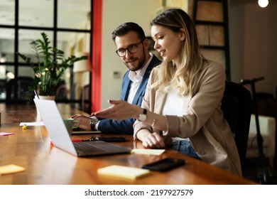 Colleagues in office. Businesswoman and businessman discussing work in office.	 - Powered by Shutterstock