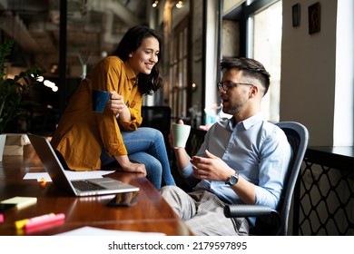 Colleagues in office. Businesswoman and businessman drinking coffee	