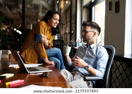 Colleagues in office. Businesswoman and businessman drinking coffee	