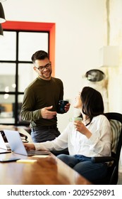 Colleagues In Office. Two Friends Drinking Coffee While Working In The Office