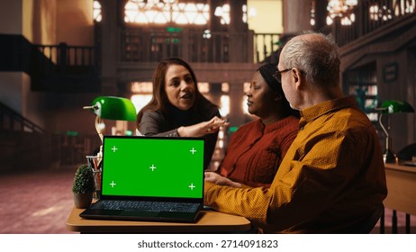 Colleagues practicing script reading in a public library with mockup, engaged in drama rehearsal and character development. Cast members preparing for classic theatre performance.