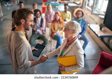 Colleagues Are Shaking Hands After A Well Done Presentation In A Pleasant Atmosphere In A Conference Room. Employees, Office, Work