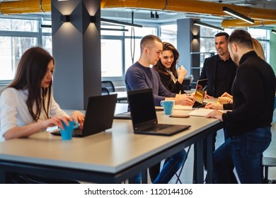 Colleagues smiling while working casually at the office meeting