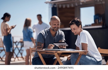 Colleagues, tablet and reading with smile, outdoor and review of statement for small business in summer. Partner, man and check for bills of store, paperwork and working on table and food truck - Powered by Shutterstock