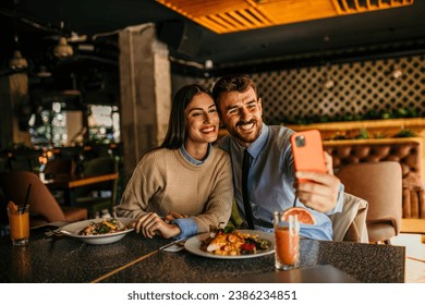 Colleagues taking a selfie and bonding over a quick lunch break - Powered by Shutterstock