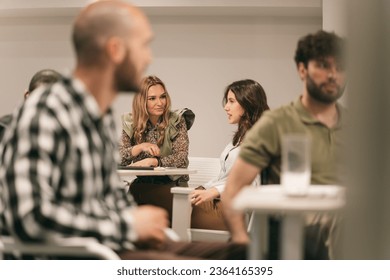 Colleagues talking and discussing while working in groups - Shutterstock ID 2364165395