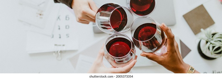 Colleagues toasting wine glasses at work - Powered by Shutterstock