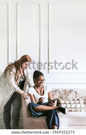 Colleagues using a digital tablet in the office