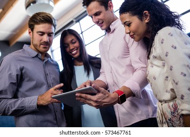 Colleagues using a tablet in the office
