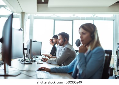 Colleagues working in a call center. - Shutterstock ID 560305249