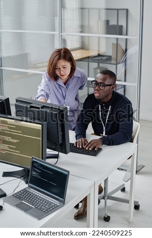 Colleagues working over new software