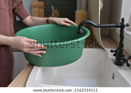 Collect water in the basin. The concept of cleaning the apartment.