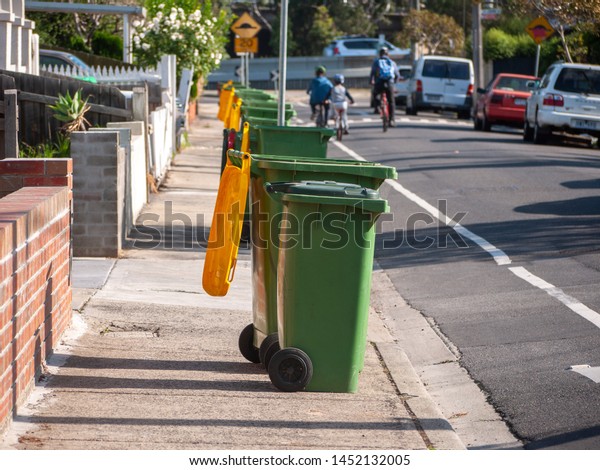 Collected kerbside waste bins\
on a residential suburban street. Melbourne, Footscray, VIC\
Australia.