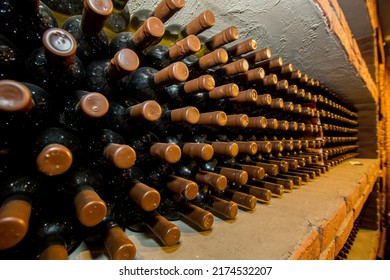 Collectible Wine Bottles In The Basement On The Shelf