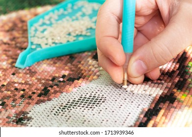 Collecting diamond embroidery, diamond mosaic. Colored crystals.