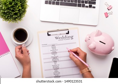 Collecting money concept. Woman planning budget before wedding writing ideas on paper