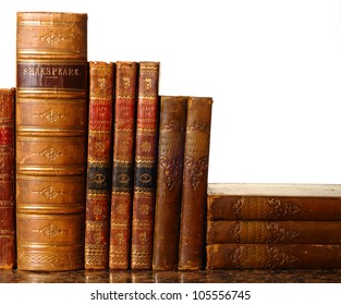 Collection of antique leather-bound books against a white background. Ancient spelling 'Shakespeare' - Powered by Shutterstock