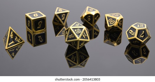 A Collection of Beautiful Polyhedral Dice (d4, d6, d8, d10, d12, and d20) for Roll Playing Fantasy Games. Black and Gold with Reflections.