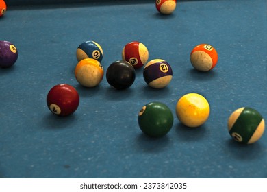 a collection of billiard balls on a billiard table.