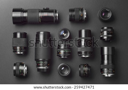 Collection of camera lens well organized over black background