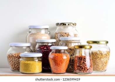 Collection Of Cereals In Storage Jars In Pantry.