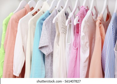 Collection of clothes hanging on a rack - Shutterstock ID 561407827