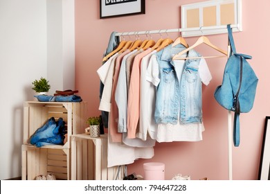 Collection Of Clothes Hanging On Rack In Dressing Room