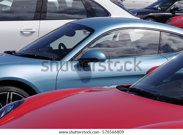 Collection of\
colorful sport cars parked in car\
park.