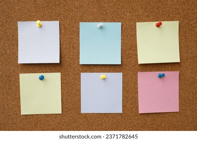 collection of colorful variety post note. paper note reminder sticky notes pin paper blue  on cork bulletin board. empty space for text.