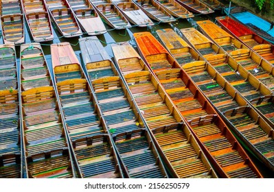 A collection of colourful punting boats on the river Thames at Oxford
