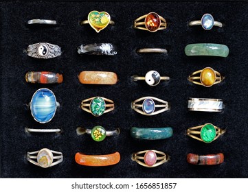 A Collection Of Costume Jewelry Rings In A Display Case